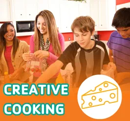 4 young adults assembling ingredients in a kitchen. 