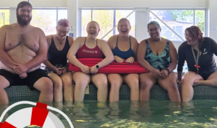 6 YMCA lifeguards smiling and laughing poolside. 